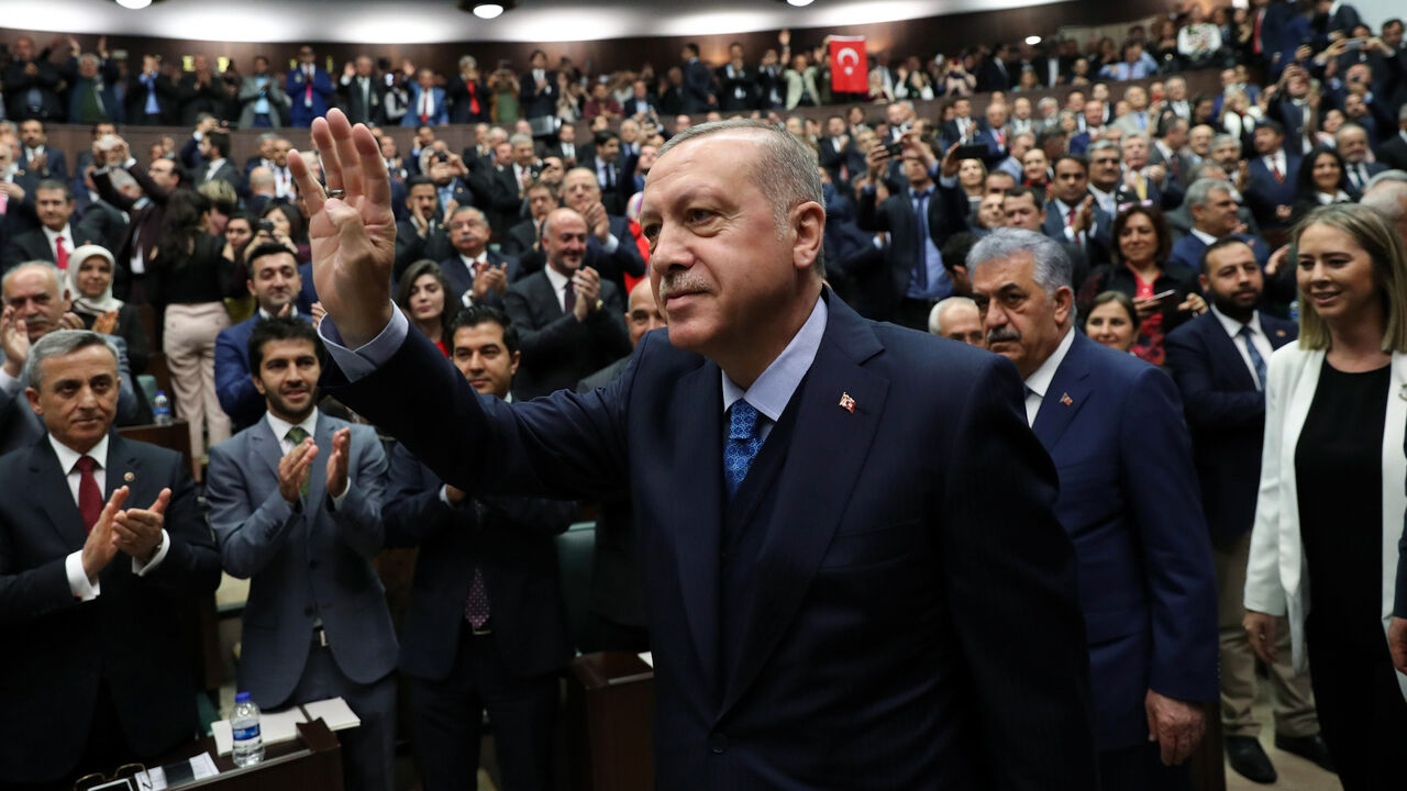 AFP_14A1JG Turkish President and leader of the Justice and Development Party (AK Party) Recep Tayyip Erdogan greets the audience by making the four-fingers Rabia sign during the AK Party's parliamentary group meeting at the Grand National Assembly of Turkey (TBMM) in Ankara, on April 24, 2018. (Photo by ADEM ALTAN / AFP) (Photo credit should read ADEM ALTAN/AFP/Getty Images)
