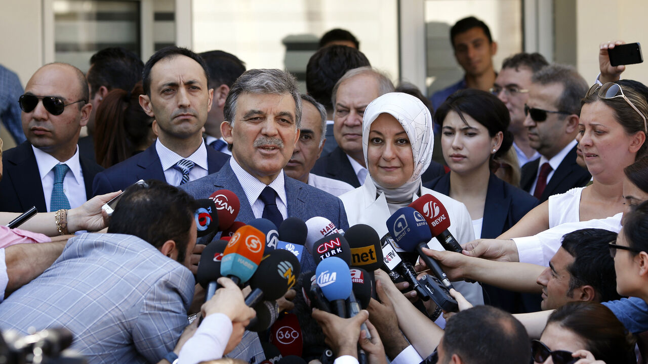 TURKEY-ELECTION/ Turkey's incumbent President Abdullah Gul and his wife Hayrunnisa Gul talk to the media as they leave a polling station after casting their votes in Ankara August 10, 2014. Turks began voting on Sunday with Tayyip Erdogan poised to become the country's first elected president, fulfilling his dream of what he calls a "new Turkey" and his opponents say will be an increasingly authoritarian nation. REUTERS/Umit Bektas (TURKEY - Tags: POLITICS ELECTIONS) - GM1EA8A1K7X01