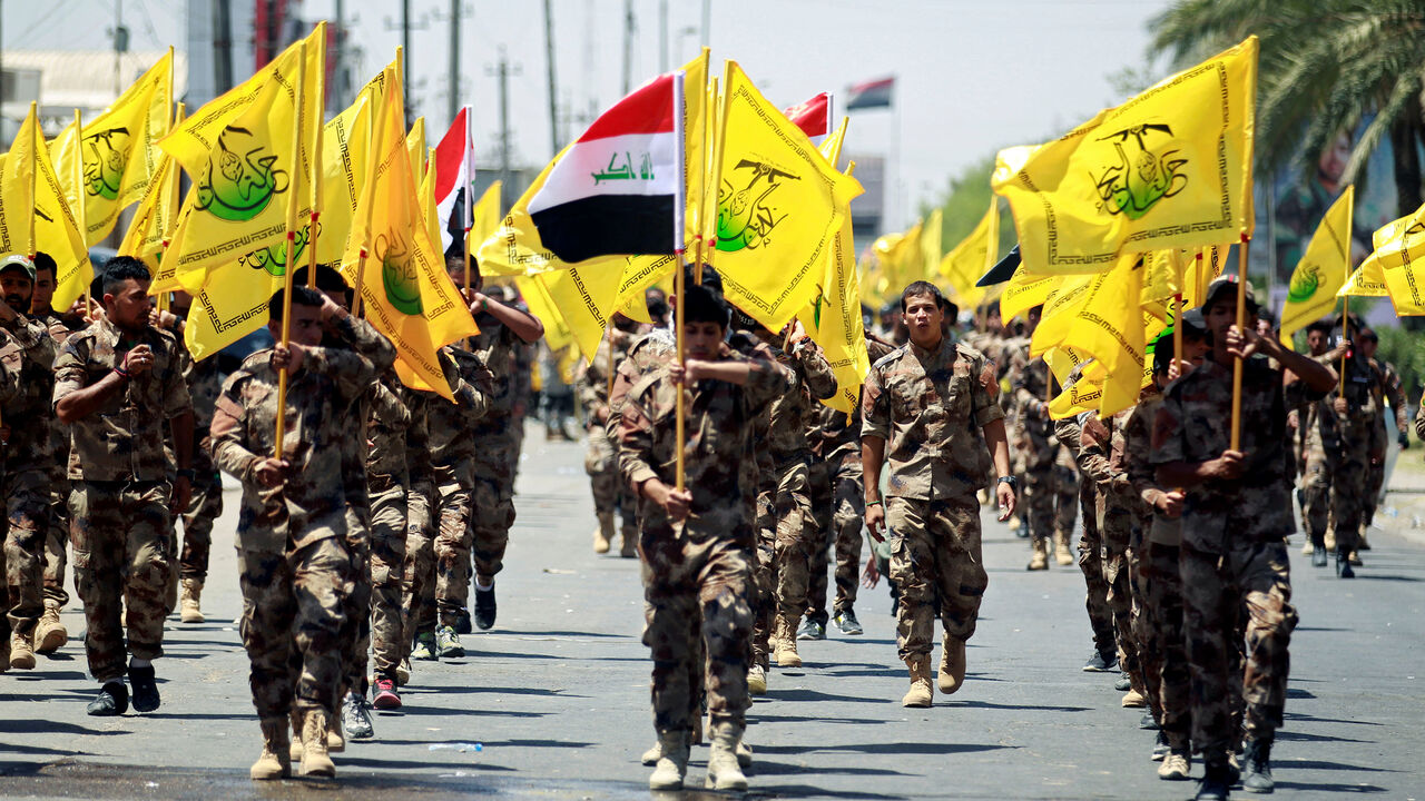 RELIGION-RAMADAN/ALQUDS-IRAQ Iraqi Shi'ite Muslims from Hashid Shaabi (Popular Mobilization) march during a parade marking the annual al-Quds Day, or Jerusalem Day, in Baghdad, Iraq June 23, 2017. REUTERS/Khalid al Mousily - RC160C330360