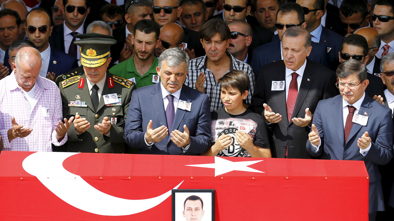 MIDEAST-CRISIS/TURKEY-PKK Turkey's President Tayyip Erdogan (2nd R), Prime Minister Ahmet Davutoglu (R), former President Abdullah Gul (4th R) and Chief of Staff General Hulusi Akar (2nd L) attend the funeral of Fehmi Sahin and Ali Koc, two of the 14 police officers who were killed during Tuesday's bombing in Igdir province in eastern Turkey, at Kocatepe Mosque in Ankara, Turkey, September 9, 2015. Daily clashes between Kurdish militants and security forces in southeast Turkey have cast doubt on whether a credible election can be he