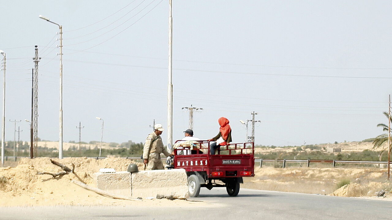 An army soldier is seen talking to locals at a check point between the northern Sinai cities of Al-Arish and Sheikh Zuwayed, May 25, 2015. Authorities in the Sinai Peninsula are battling insurgents who support Islamic State, the militant group that has seized parts of Iraq, Syria and Libya. The Sinai conflict, which has has displaced hundreds of Egyptians, is the biggest security challenge for President Abdel Fattah al-Sisi, who has promised to deliver stability after four years of turmoil triggered by the 