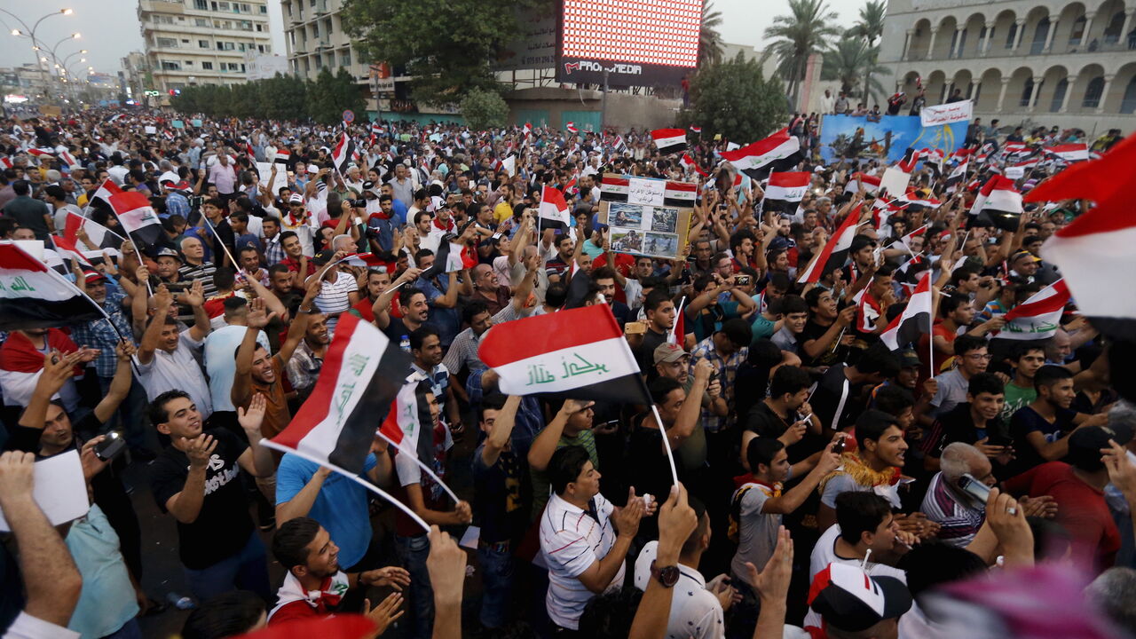 MIDEAST-CRISIS/IRAQ-REFORMS Iraqi people shout slogans during a demonstration against the poor quality of basic services, power outages and calling for trial of corrupt politicians in Baghdad, Iraq, August 28, 2015. Iraqi Prime Minister Haider al-Abadi on Friday ordered security forces to ease access to Baghdad's fortified Green Zone and main streets, in an apparent bid to improve daily life for ordinary Iraqis as fresh protests erupted across the country. Tens of thousands of demonstrators filled Baghdad's Tahrir Square on Friday in