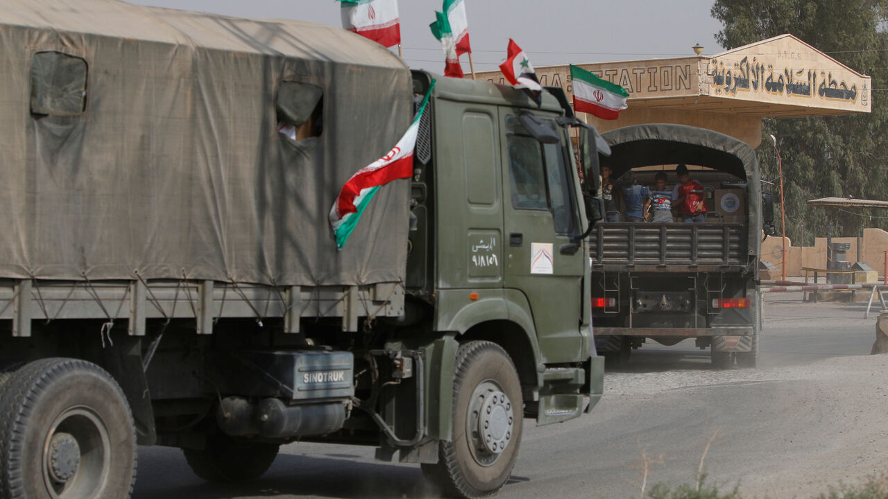MIDEAST-CRISIS/SYRIA-DEIR AL-ZOR Iranian and Syrian flags flutter on a truck carrying humanitarian aid in Deir al-Zor, Syria September 20, 2017. Picture taken September 20, 2017. REUTERS/Omar Sanadiki - RC1C8E382200