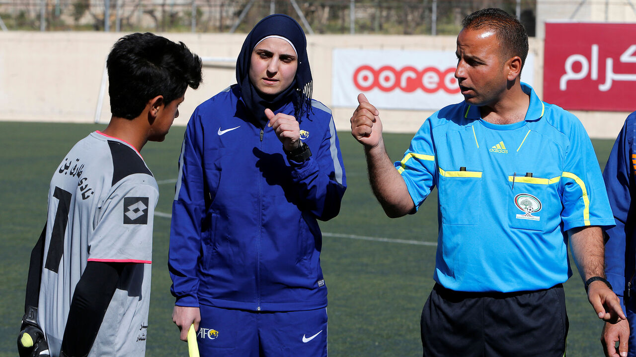PALESTINIANS-WOMAN/REFEREE Female Palestinian football referee Yasmeen Nayroukh, 29, the only one accredited to run all-male games in the West Bank, prepares before a local soccer match in Hebron, in the occupied West Bank February 26, 2018. Picture taken March 26, 2018. REUTERS/Mussa Qawasma - RC1FE9E2BD90
