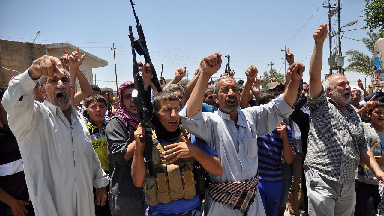 Nic6342386 Iraqi Turkmen shout slogans holding weapons as they gather to express their willingness to join Iraqi security forces in the fight against Jihadist militants who have taken over several northern Iraqi cities on June 23, 2014, in the Iraqi village of Taza Khormato, 20 kilometers south of the city of Kirkuk. Sunni Arab militants hold a string of towns and surrounding areas west and south of the the ethnically mixed oil city of Kirkuk. AFP PHOTO / MARWAN IBRAHIM (Photo credit should read MARWAN IBRAHIM