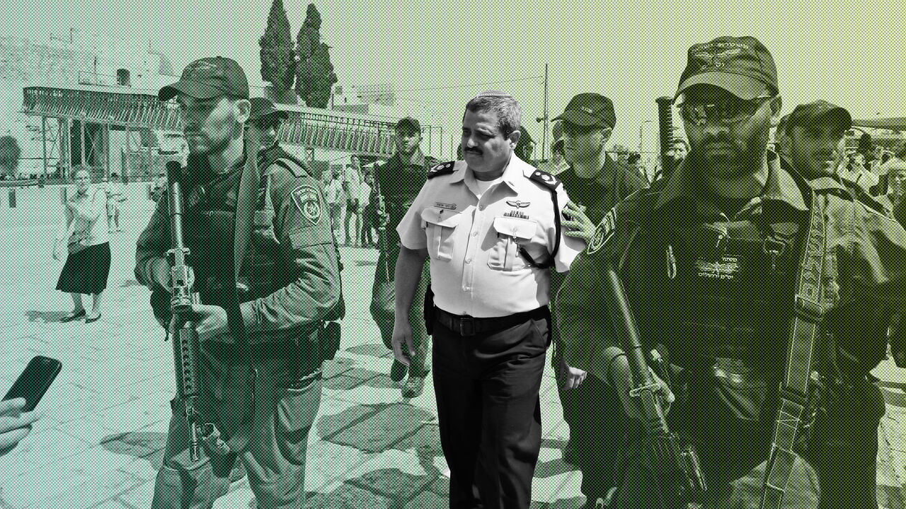 AFP_R08I8 Chief of the Israeli police, Commissioner Roni Alsheikh (C), leaves after speaking to the press at the Western Wall in Jerusalem, on the ongoing tensions surrounding the Al-Aqsa mosque compound on July 27, 2017. / AFP PHOTO / GALI TIBBON (Photo credit should read GALI TIBBON/AFP/Getty Images)