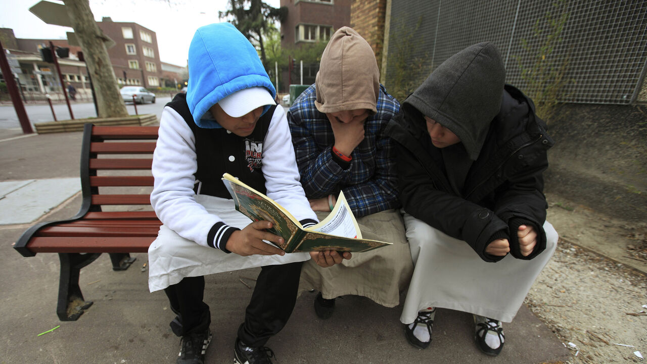 FRANCE Teenagers read the Koran in Paris March 31, 2012. Picture taken March 31, 2012. REUTERS/Zohra Bensemra (FRANCE - Tags: SOCIETY RELIGION) - GM1E8421QDA01