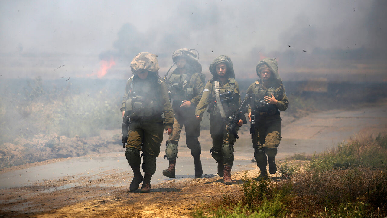ISRAEL-USA/PROTESTS-GAZA BORDER Israeli soldiers patrol near a burning field on the Israeli side of the border between Israel and Gaza, May 14, 2018. REUTERS/Amir Cohen TPX IMAGES OF THE DAY - RC1FB2222060