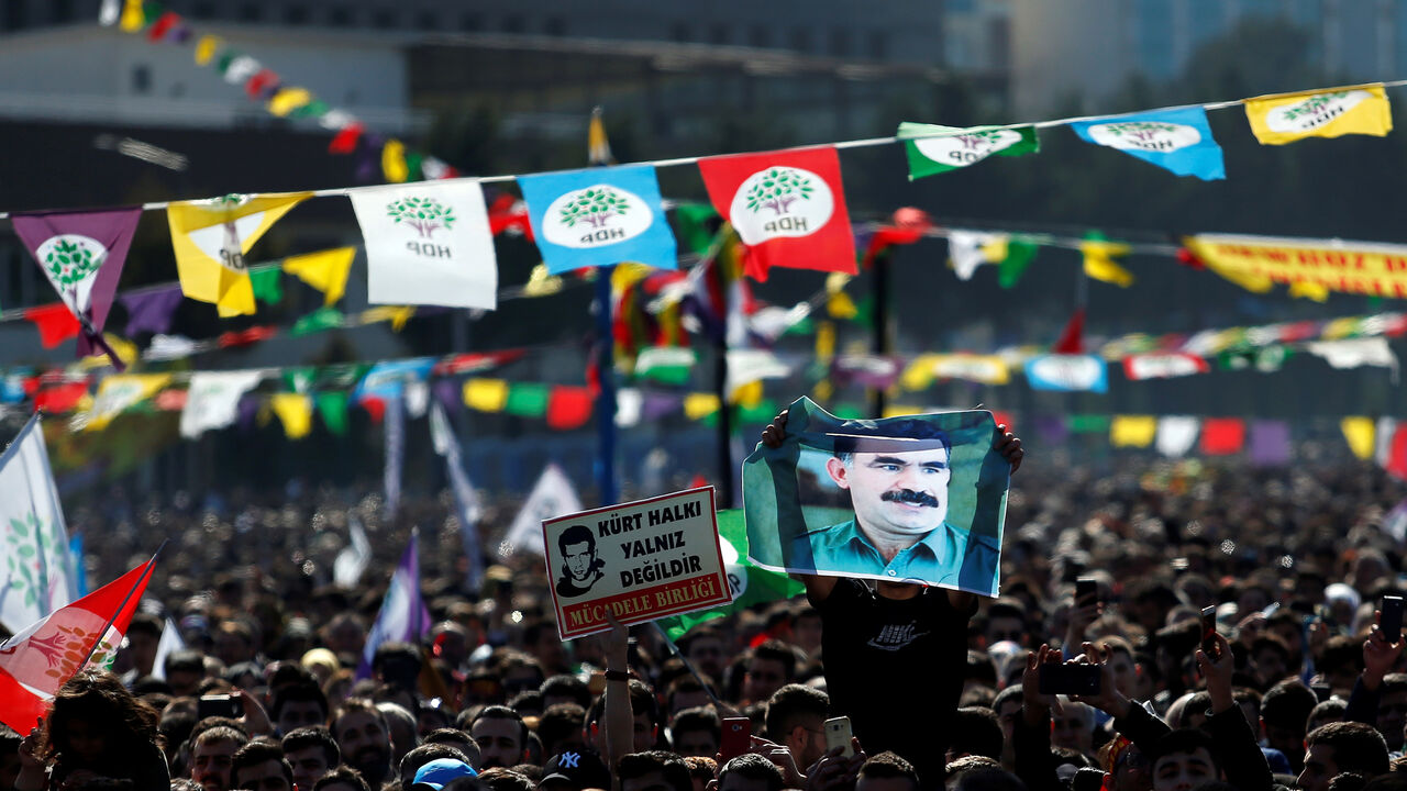 TURKEY-KURDS/PEACE A man holds a picture of jailed Kurdistan Workers Party (PKK) leader Abdullah Ocalan as people gather to celebrate Newroz, which marks the arrival of spring and the new year, in Istanbul, Turkey March 24, 2019. REUTERS/Kemal Aslan - RC1291C94940