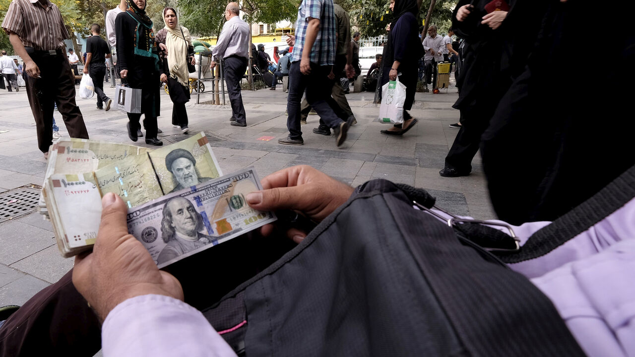 IRAN-BANKING A money changer displays U.S. and Iranian banknotes at the Grand Bazaar in central Tehran October 7, 2015. To match Insight IRAN-BANKING/ REUTERS/Raheb Homavandi/TIMA/File Photo ATTENTION EDITORS - THIS IMAGE WAS PROVIDED BY A THIRD PARTY. EDITORIAL USE ONLY. - S1BETSJMVNAC
