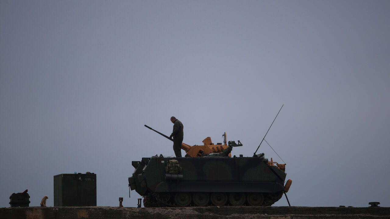 MIDEAST-CRISIS/SYRIA-TURKEY A Turkish soldier stands on an armoured vehicle in a village near the Turkish-Syrian border in Hatay province, Turkey February 25, 2018. REUTERS/Umit Bektas - RC174F023F10