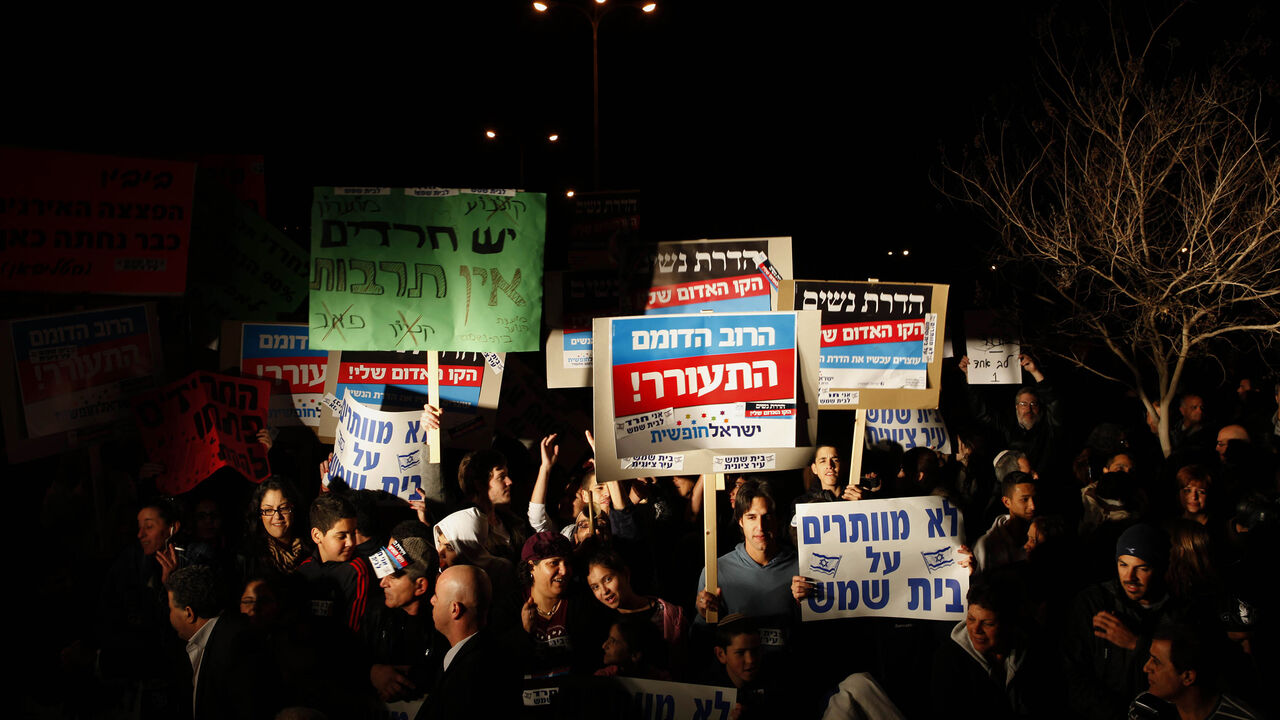 Israelis protest against gender segregation and violence towards women by ultra Orthodox Jewish extremists on December 27, 2011 in the town of Beit Shemesh, near Jerusalem. The protest comes after a wave of incidents in Israel in which women have been compelled to sit at the back of segregated buses serving ultra-Orthodox areas or get off, despite court rulings that women may sit where they please. AFP PHOTO/GALI TIBBON (Photo credit should read GALI TIBBON/AFP/Getty Images)