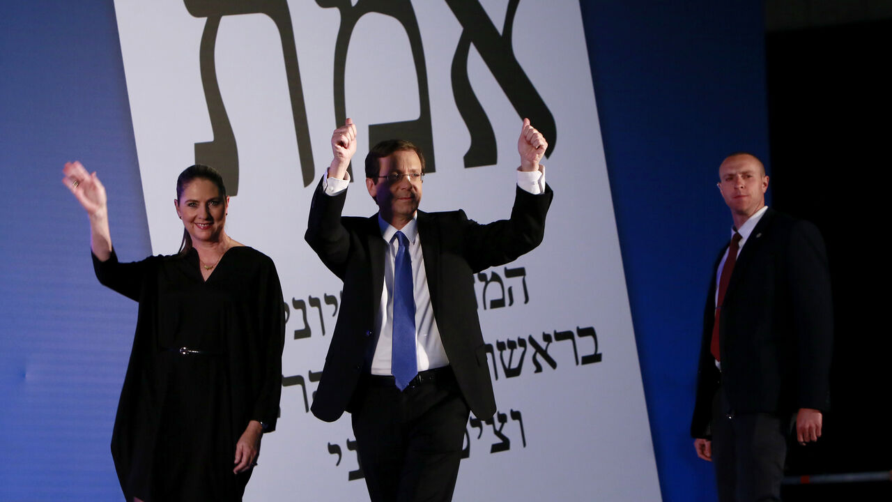 Nic6429642 Co-leader of the Zionist Union party, Israeli Labour Party leader Isaac Herzog (C), arrives on stage with his wife Michal as he reacts to exit poll figures in Israel's parliamentary elections late on March 17, 2015 in the city of Tel Aviv. Israeli Prime Minister Benjamin Netanyahu's rightwing Likud party is neck-and-neck with the centre-left Zionist Union, exit polls say. AFP PHOTO / GALI TIBBON (Photo credit should read GALI TIBBON/AFP/Getty Images)