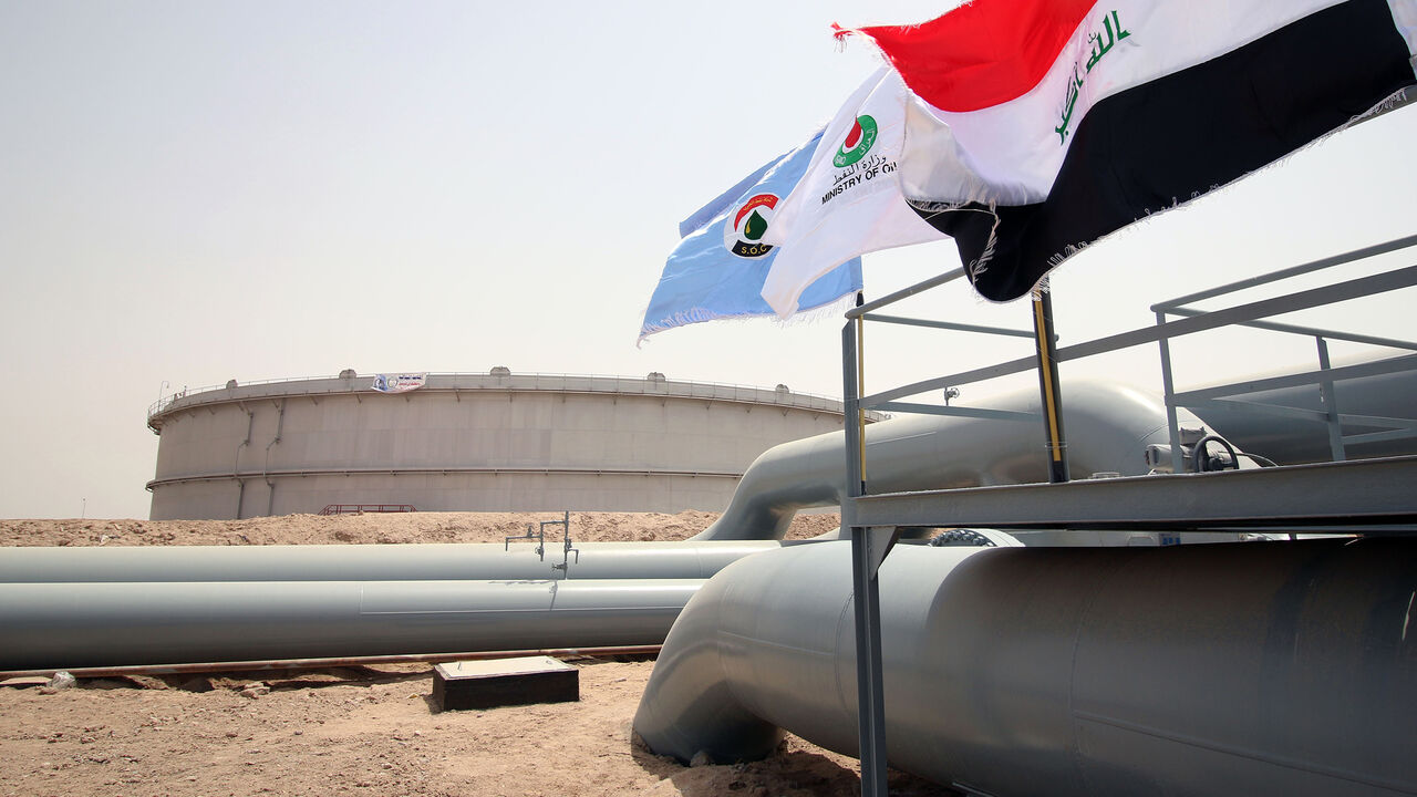 Nic6457273 A picture taken on May 31, 2015 shows Iraqi flags fluttering in front of a tank for oil at al-Fao (also spelled al-Faw) storage terminal, located on the al-Fao Peninsula, south of the Iraqi province of Basra. AFP PHOTO / HAIDAR MOHAMMED ALI (Photo credit should read HAIDAR MOHAMMED ALI/AFP/Getty Images)