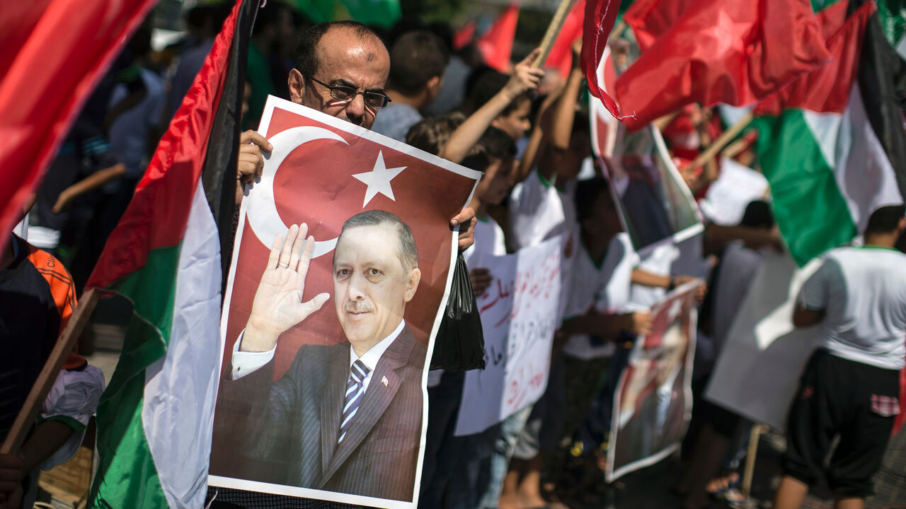 AFP_D93JM Palestinian supporters of the Hamas movement hold portraits of Turkish President Recep Tayyip Erdogan as they shout slogans against the military coup attempt in Turkey, during a demonstration in Gaza City, on July 16, 2016.
Erdogan battled to regain control over Turkey on July 16, 2016 after a coup bid by discontented soldiers, as signs grew that the most serious challenge to his 13 years of dominant rule was faltering. After a night of drama and bloodshed, at least 90 people had died and more than 1,150 pe