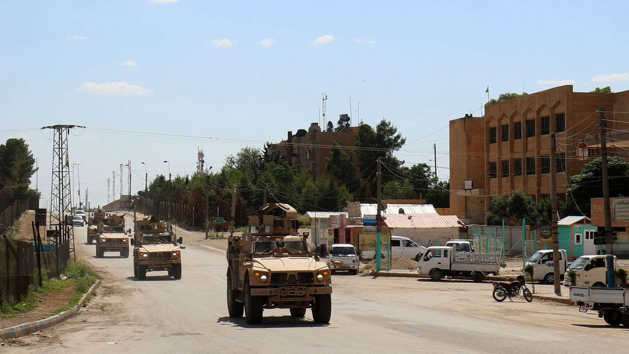 AFP_15M9LK Vehicles of the US-led coalition battling the Islamic State group patrol the town of Rmelane in Syria's Hasakeh province on June 5, 2018. - The leading Syrian Kurdish militia said it would withdraw from Manbij, easing fears of a direct clash between NATO allies Washington and Ankara over the strategic northern town. Manbij is a Sunni Arab-majority town that lies just 30 kilometres (19 miles) south of the Turkish border, and where US and French troops belonging to the Western coalition against IS are station