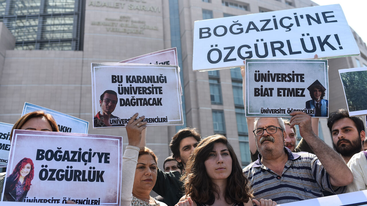 AFP_15N6WW People demonstrate outside the Caglayan courthouse on June 6, 2018 in Istanbul with banners reading "Freedom for Bogazici" as a trial opens today of 21 students from Bogazici University described by Turkey's President as "terrorists" after they opposed the Turkish military operation in Syria launched in January 2018. (Photo by Yasin AKGUL / AFP) (Photo credit should read YASIN AKGUL/AFP/Getty Images)
