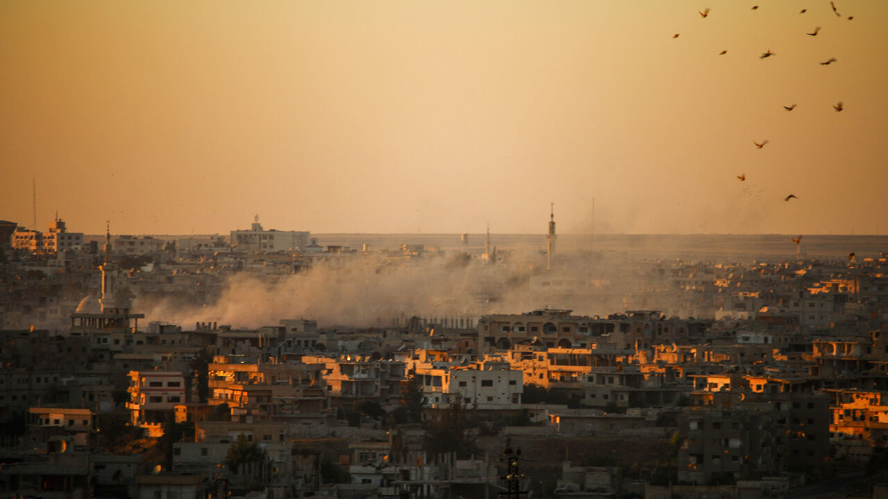 Smoke rises above opposition held areas of Daraa during airstrikes by Syrian regime forces on June 26, 2018. - Russian-backed regime forces have for weeks been preparing an offensive to retake Syria's south, a strategic zone that borders both Jordan and the Israeli-occupied Golan Heights. (Photo by Mohamad ABAZEED / AFP)        (Photo credit should read MOHAMAD ABAZEED/AFP/Getty Images)