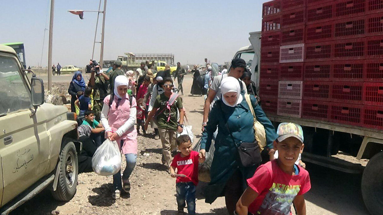 People walk as they hold their belongings in Deraa countryside, Syria in this handout released on June 28, 2018. SANA/Handout via REUTERS ATTENTION EDITORS - THIS PICTURE WAS PROVIDED BY A THIRD PARTY. REUTERS IS UNABLE TO INDEPENDENTLY VERIFY THE AUTHENTICITY, CONTENT, LOCATION OR DATE OF THIS IMAGE - RC1C2E612270