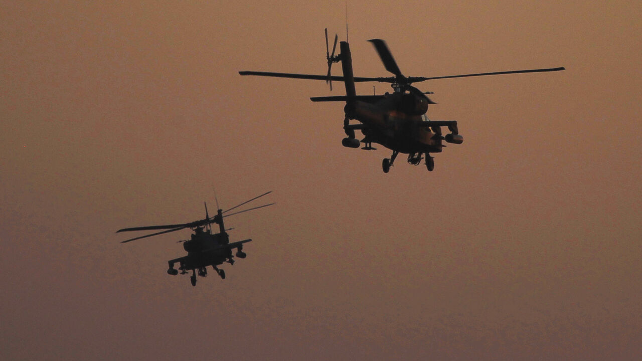 EGYPT-PROTESTS Apache helicopters fly over Tahrir Square during a protest to support the army, in Cairo July 26, 2013. Ousted Egyptian president Mohamed Mursi is under investigation for an array of charges including murder, the state news agency said on Friday, stoking tensions as opposing political camps took to the streets. Confirming the potential for bloodshed, two men were killed in confrontations in Egypt's second city Alexandria and a further 19 were hurt, Mena news agency reported. REUTERS/Amr Abdallah Dalsh (EGYP