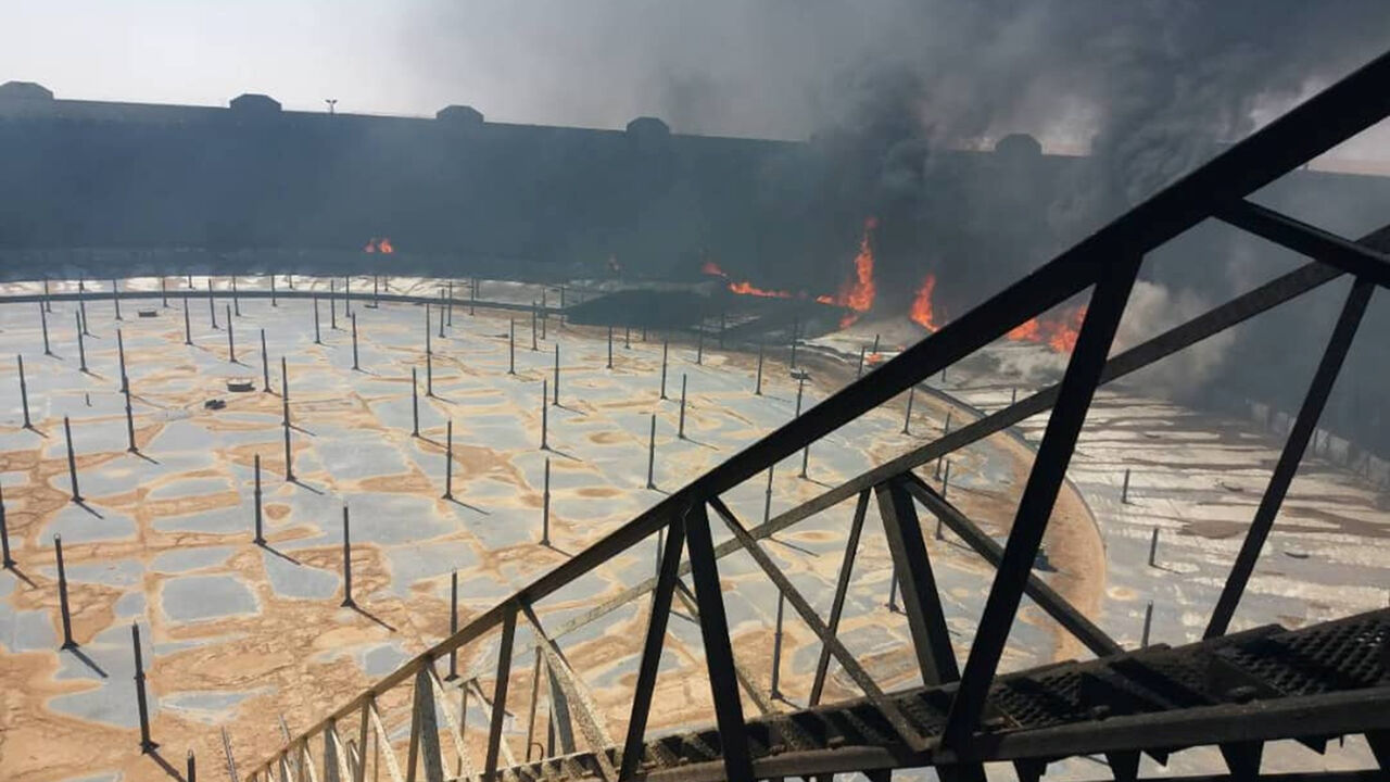 LIBYA-SECURITY/OIL Smoke and flame rise from an oil storage tank that was set on fire amid fighting between rival factions at Ras Lanuf terminal, Libya in this handout picture released on June 16, 2018. The National Oil Corporation/ Handout via Reuters ATTENTION EDITORS - THIS PICTURE WAS PROVIDED BY A THIRD PARTY. REUTERS IS UNABLE TO INDEPENDENTLY VERIFY THIS IMAGE. - RC1597B41120
