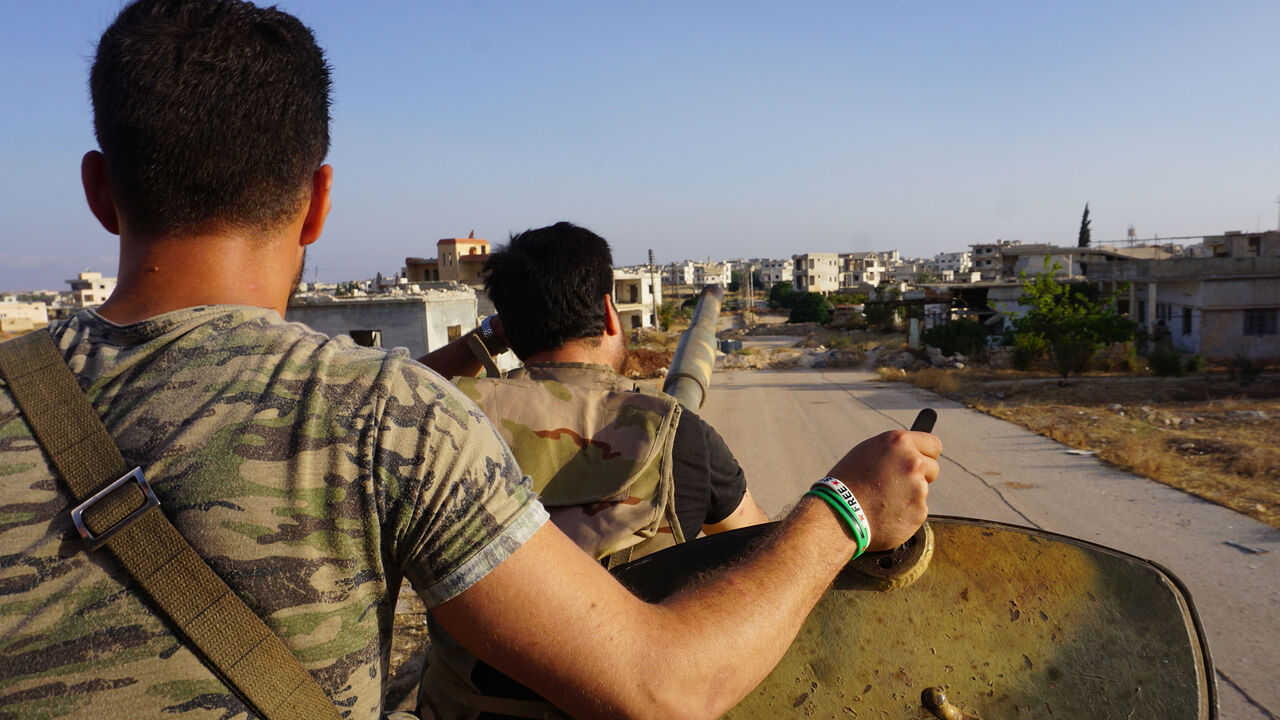 AFP_17S4UP A picture taken on July 19, 2018 shows rebel fighters on a tank, entering town of Fuaa in the northwestern Syrian province of Idlib after thousands of its residents were evacuated to regime-controlled areas. - Several thousand residents evacuated two pro-regime towns in northern Syria today, putting an end to one of the longest sieges of the country's seven-year civil war.
Fuaa and Kafraya in Idlib province were the last remaining areas under blockade in Syria and a rare example of pro-government towns surr