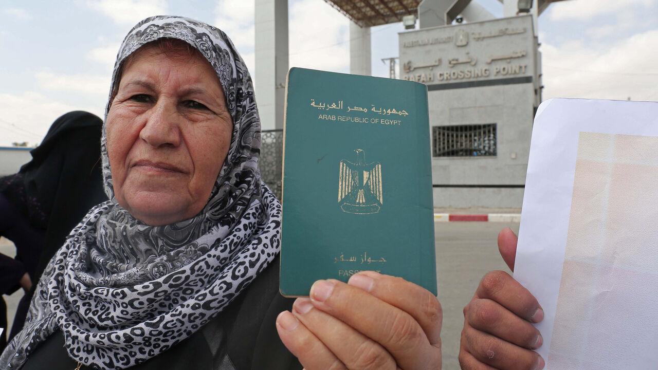 AFP_QC6IW A Palestinian woman holds her passport during a rally at the Rafah border crossing between Egypt and Gaza calling on Egypt to open the crossing, in the southern Gaza Strip on July 6, 2017.
Hamas leader Ismail Haniya said recent talks in Egypt could lead to improving the humanitarian suffering in the impoverished Gaza Strip. / AFP PHOTO / SAID KHATIB (Photo credit should read SAID KHATIB/AFP/Getty Images)