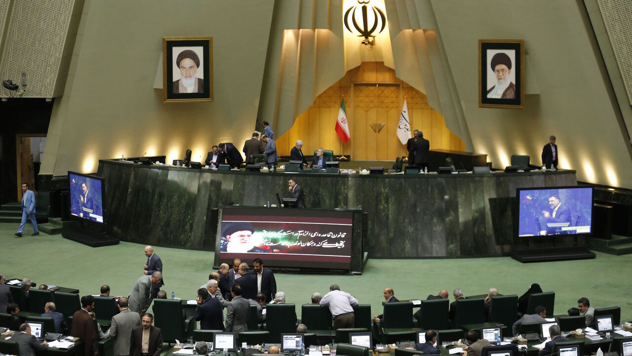 AFP_12G29Y Iranian MPs are seen during a meeting of the Iranian parliament for the impeachment of the Minister of Labor on March 13, 2018. / AFP PHOTO / ATTA KENARE (Photo credit should read ATTA KENARE/AFP/Getty Images)