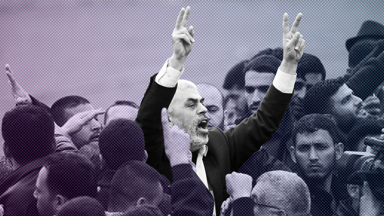 AFP_13F83D Islamist Hamas movement leader Yahya Sinwar (C) shouts slogans and flashes the victory gesture as he takes part in a tent city protest near the border with Israel east of Jabalia in the northern Gaza strip on March 30, 2018 to commemorate Land Day.
Land Day marks the killing of six Arab Israelis during 1976 demonstrations against Israeli confiscations of Arab land. / AFP PHOTO / Mohammed ABED (Photo credit should read MOHAMMED ABED/AFP/Getty Images)