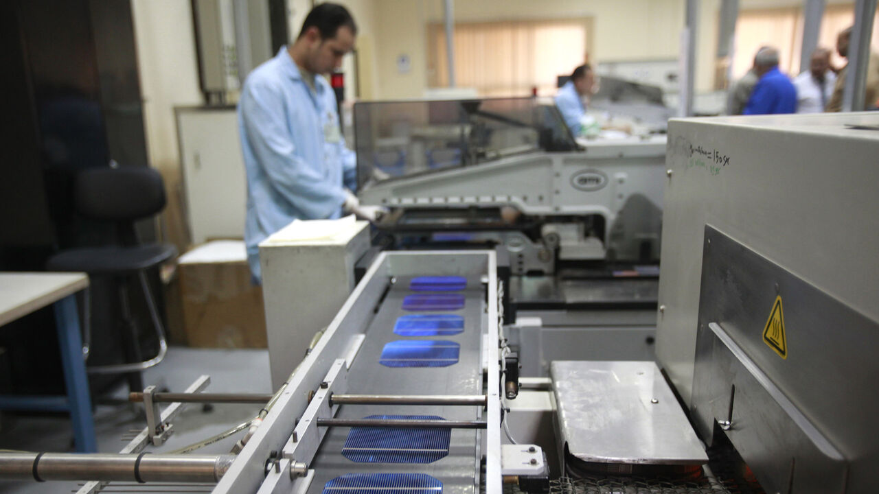 EGYPT/ An employee is seen on the production line of the solar energy department at the Arab International Optronics (AIO) factory on the outskirts of Cairo, November 17, 2011. Picture taken November 17, 2011. REUTERS/Asmaa Waguih (EGYPT - Tags: MILITARY ENERGY POLITICS) - LR2E84410PK0W