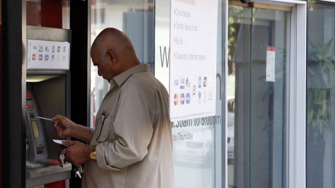 EGYPT-REPOS/ (MIDEAST DEBT) A man withdraws money from an ATM machine outside of a bank in Cairo, August 27, 2012. Demand for the Egyptian central bank's repurchasing agreement (repo) facility has fallen back after shooting up in June, indicating that short-term pressure on the banking system may be easing as more money flows into the country. The government introduced the facility in March last year to boost liquidity in Egypt's turbulent financial markets a month after President Hosni Mubarak resigned in the wake of a popular uprisi