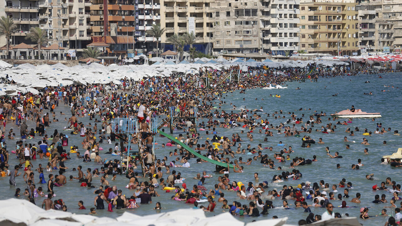 EGYPT-ELMAX/WIDERIMAGE Egyptians crowd a public beach during a hot day in the Mediterranean city of Alexandria September 5, 2014. El Max, in Alexandria, where hundreds of boats dart through the canals, has been called the "Venice of Egypt" for its waterways and relaxed atmosphere. Its fishermen, however, worry about how they will make ends meet on meagre earnings they say are being reduced further by polluted waters that are making fishing more difficult. While the government has tried to fix the state's bloated finances by cutti