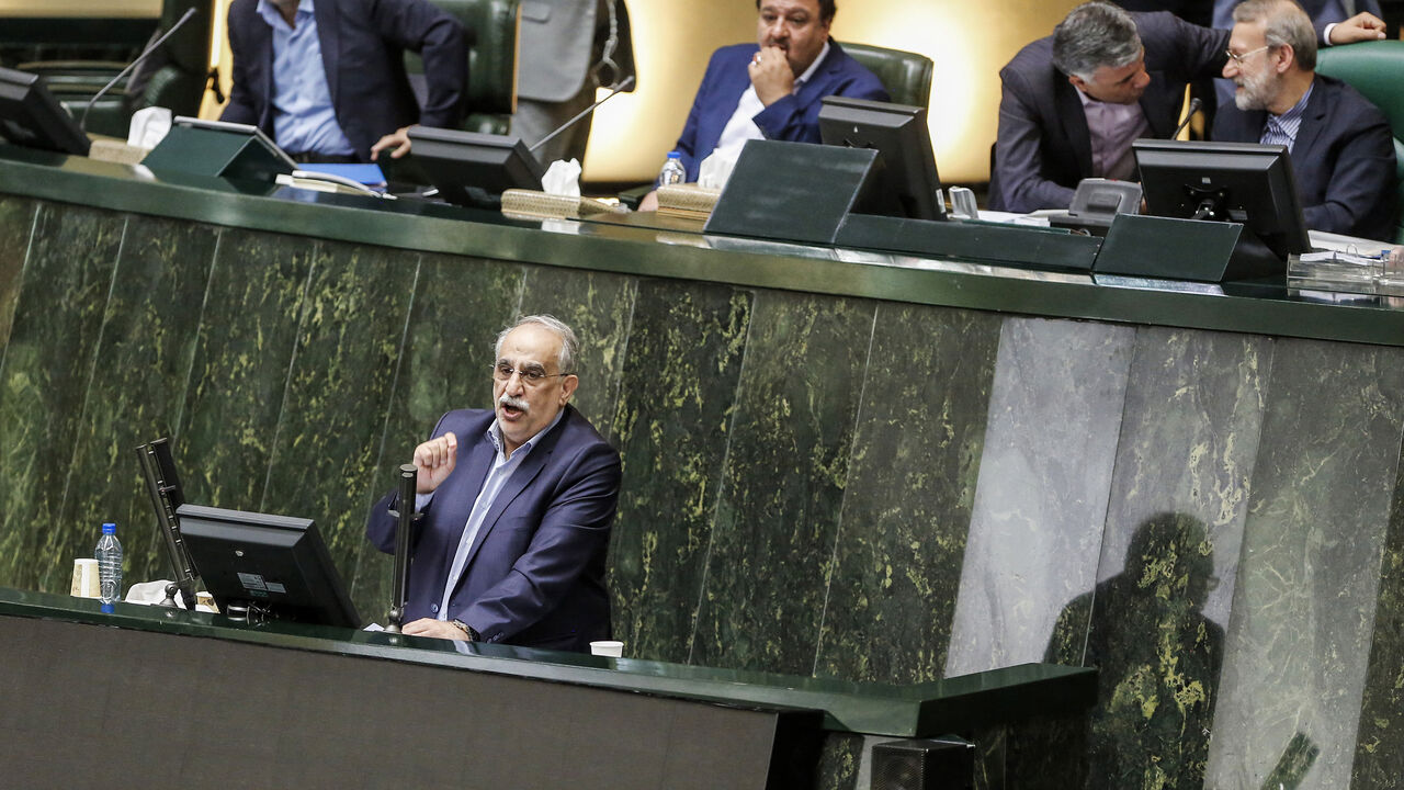 AFP_18M1I2 Masoud Karbasian (bottom), Iran's Economy Minister, speaks in parliament in the capital Tehran on August 26, 2018 before a vote by lawmakers which saw him impeached. - Karbasian is the second minister in President Hassan Rouhani's cabinet to be impeached this month, following the removal of Labour Minister Ali Rabiei on August 8. (Photo by ATTA KENARE / AFP) (Photo credit should read ATTA KENARE/AFP/Getty Images)