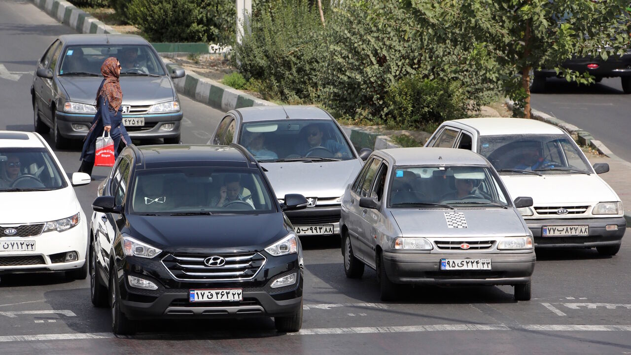 Nic6484936 TO GO WITH AFP STORY BY ALI NOORANI - A picture taken on September 12, 2015 shows Iranians driving a Pride car manufactured by SAIPA group (R) and a Hyundai ix45 luxury car (L) in northern Tehran. A campaign to boycott "substandard and expensive" Iranian-made cars has fired up social media in the Islamic republic, where its supporters have been accused of anti-revolutionary treason. AFP PHOTO / ATTA KENARE (Photo credit should read ATTA KENARE/AFP/Getty Images)