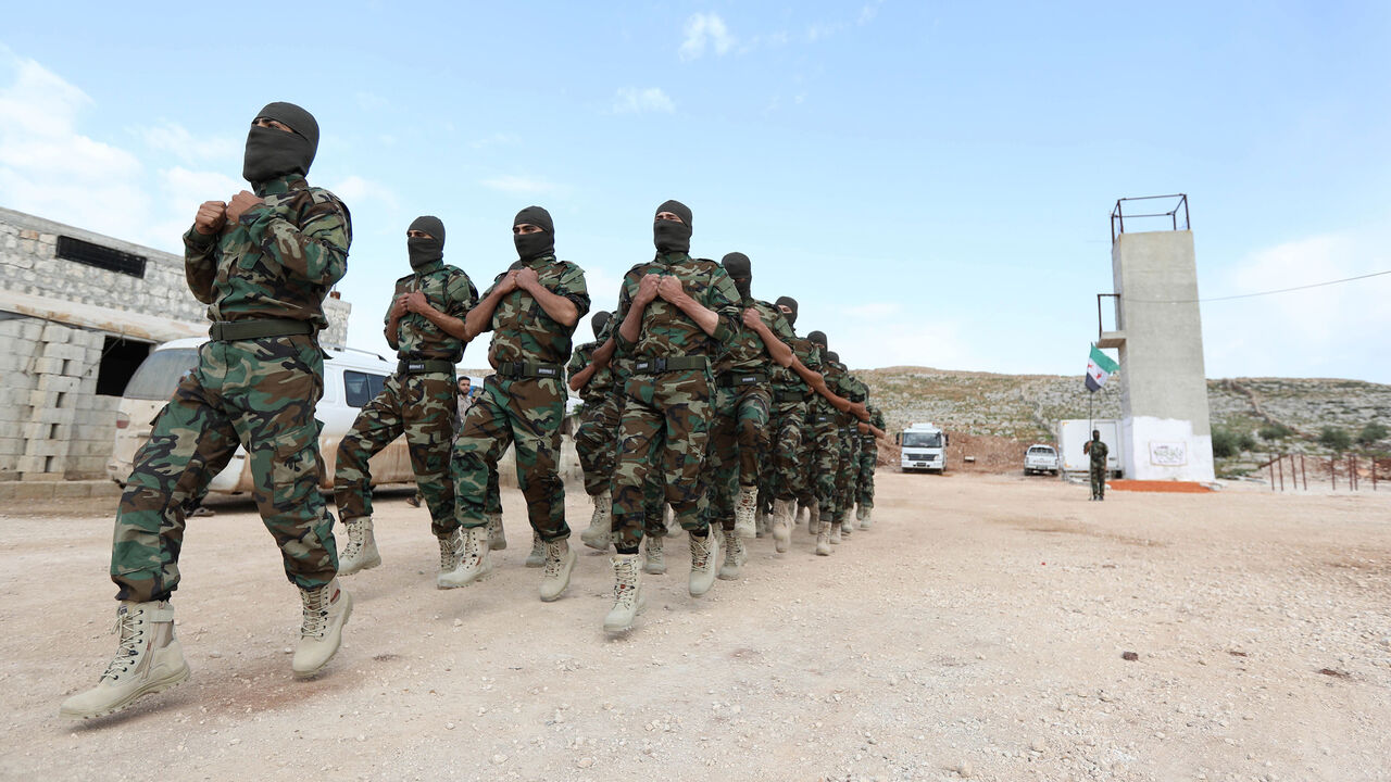 AFP_13U923 Fighters from the Jaysh al-Izza (the Army of Glory), affiliated with the Turkish-backed Free Syrian Army, take part in a training session in the northwestern Syrian city of Idlib on April 9, 2018. / AFP PHOTO / OMAR HAJ KADOUR (Photo credit should read OMAR HAJ KADOUR/AFP/Getty Images)
