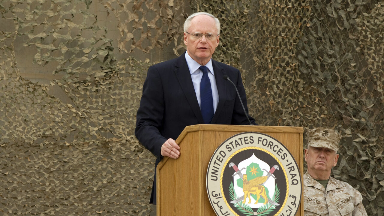IRAQ-WITHDRAWAL/ U.S. ambassador to Iraq James Jeffrey (L) speaks during a ceremony for the U.S. military to retire its ceremonial flags, signifying the end of military presence in Iraq, at the Baghdad Diplomatic Support Center in Baghdad December 15, 2011. The U.S military officially ended its war in Iraq on Thursday, rolling up its flag at a low-key ceremony with Panetta nearly nine years after the invasion that ousted Saddam Hussein. This ceremony is called the "casing of the colors" and signifies the departing and inact