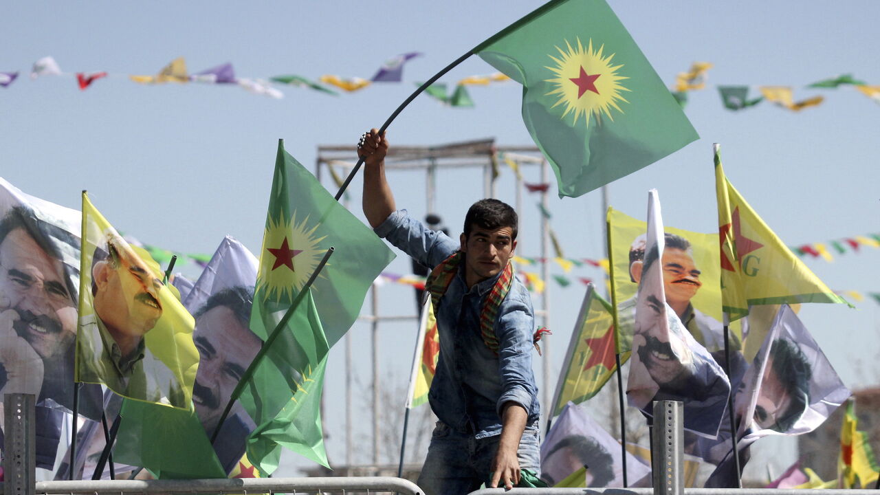 TURKEY-KURDS/ A demonstrator waves a flag of the outlawed Kurdistan Workers Party (PKK) during a gathering to celebrate the spring festival of Newroz in the Kurdish-dominated southeastern city of Diyarbakir, Turkey March 21, 2016. Turkey's Kurds on Monday marked the annual spring festival of Newroz with a call for the resumption of peace talks between the government and Kurdish militants, but four Turkish soldiers were killed in another rebel attack in the restive southeast region. REUTERS/Sertac Kayar - GF10000354403