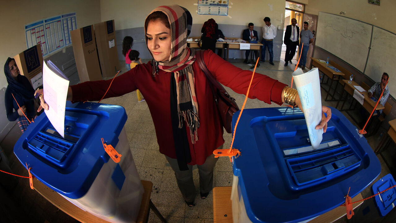 Nic6322770 An Iraqi woman casts her vote in Iraq's parliamentary election (ballot-L) and in a postponed Kurdish regional election (ballot-R) in Arbil, the capital of the autonomous Kurdish region of northern Iraq, on April 30, 2014. Iraqis streamed to voting centres nationwide, amid the worst bloodshed in years, as Prime Minister Nuri al-Maliki seeks reelection. AFP PHOTO / SAFIN HAMED (Photo credit should read SAFIN HAMED/AFP/Getty Images)