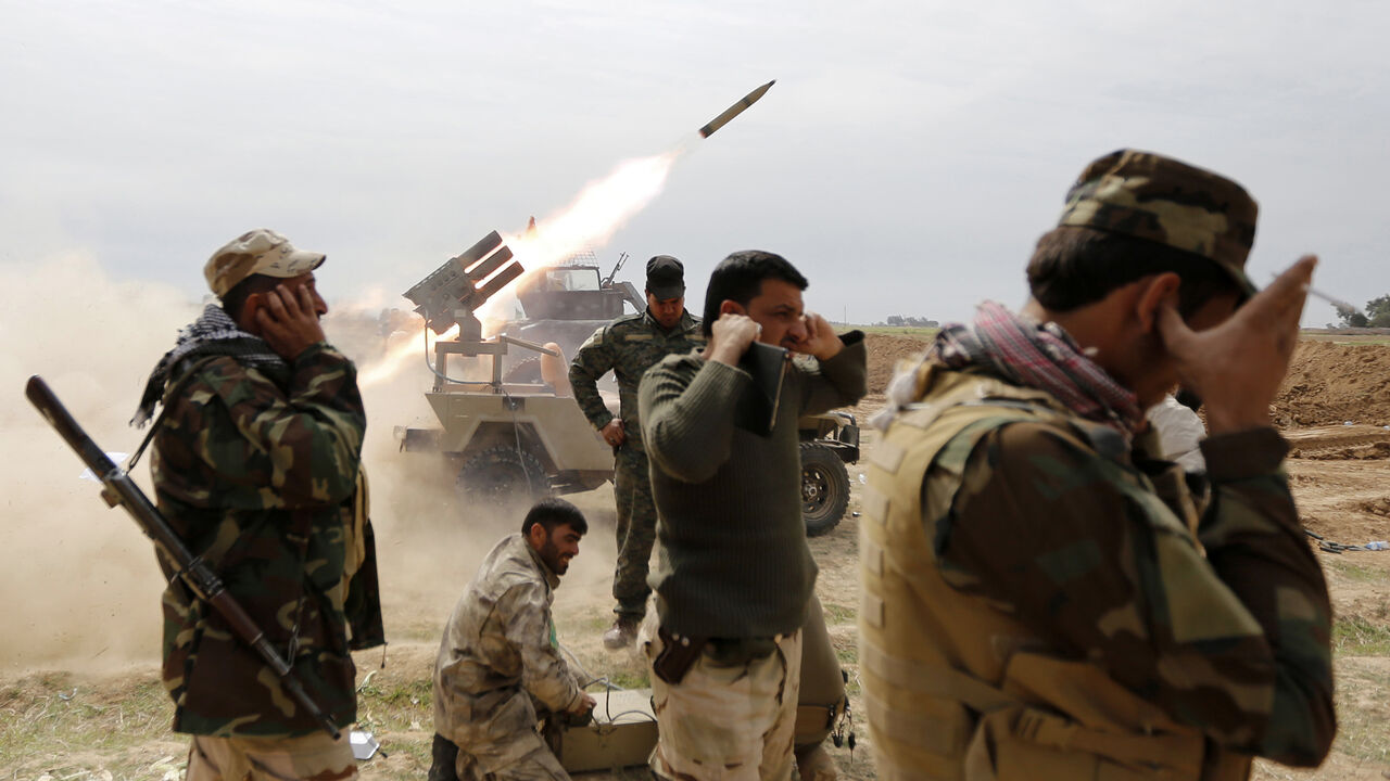 Shi'ite fighters cover their ears as a rocket is launched during a clash with Islamic State militants in the town of al-Alam March 9, 2015. Just north of Tikrit, home city of executed Sunni former president Saddam Hussein, Iraqi security forces and Shi?ite militia fighters began an offensive against Islamic State to regain control over the town of al-Alam.   REUTERS/Thaier Al-Sudani (IRAQ - Tags: POLITICS CIVIL UNREST CONFLICT TPX IMAGES OF THE DAY) - GM1EB3A0BP801