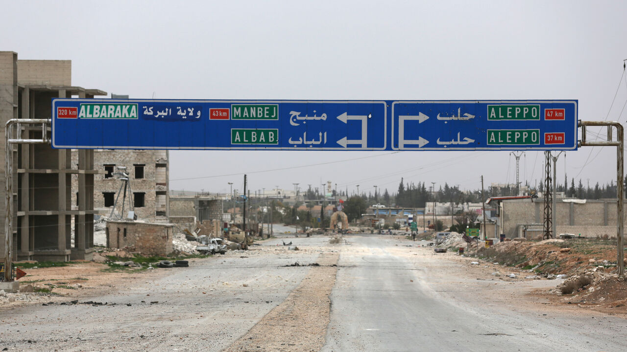MIDEAST-CRISIS/SYRIA-NORTH A road sign that shows the direction to Manbij city is seen in the northern Syrian town of al-Bab, Syria March 1, 2017. Picture taken March 1, 2017. REUTERS/Khalil Ashawi - RC15D78AB000
