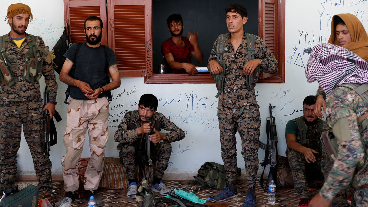 MIDEAST-CRISIS/SYRIA-RAQQA Kurdish fighters from the People's Protection Units (YPG) stand outside a house in Raqqa, Syria June 21, 2017. REUTERS/Goran Tomasevic - RC1494327B10