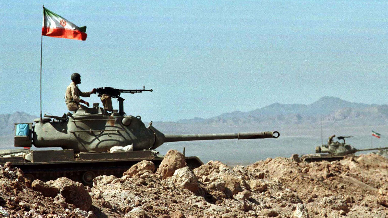 IRAN Iranian soldiers sit atop their tanks in an Iranian border province next to Afghanistan October 1. Iranian forces staged mock attacks close to the border with Afghanistan in preparation for war-games involving over 200,000 troops. - PBEAHUMFTDH
