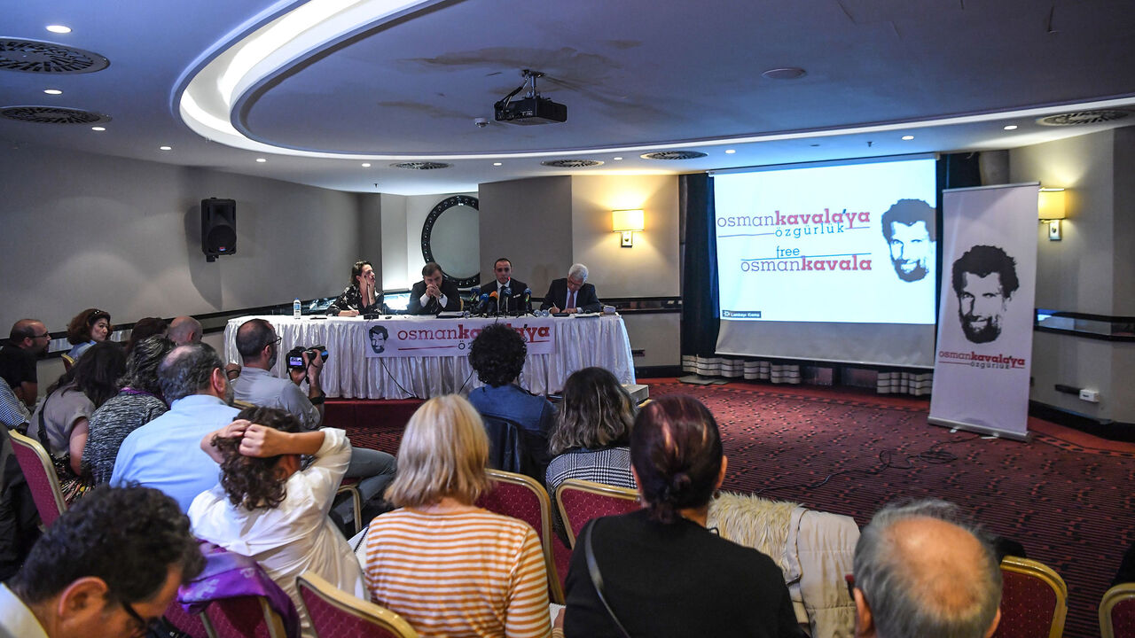 AFP_1AG7BJ Jailed businessman and philanthropist Osman Kavala's lawyers attend a press conference on October 31, 2018 to ask Osman Kavala's release, - Osman Kavala was arrested a year ago by Turkish authorities and has still to be charged with an offence. (Photo by OZAN KOSE / AFP) (Photo credit should read OZAN KOSE/AFP/Getty Images)
