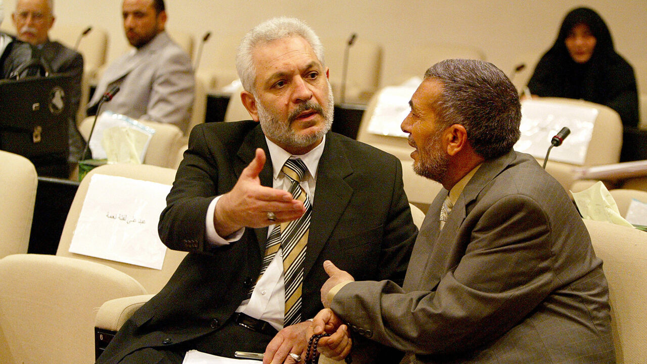 DV43766 Baghdad, IRAQ: Iraqi deputy Ali al-Adib (L), member of the Shiite Iraqi al-Dawa Party chats with Sunni speaker Mahmud Mashhadani prior the start of the parliament session in Baghdad's heavily fortified green zone, 17 May 2006. Iraqi prime minister designate Nuri al-Maliki will present his cabinet line-up for parliamentary approval on Saturday, deputy parliamentary speaker Sheikh Khalid al-Attiya said today. AFP PHOTO/POOL SABAH ARAR (Photo credit should read SABAH ARAR/AFP/Getty Images)