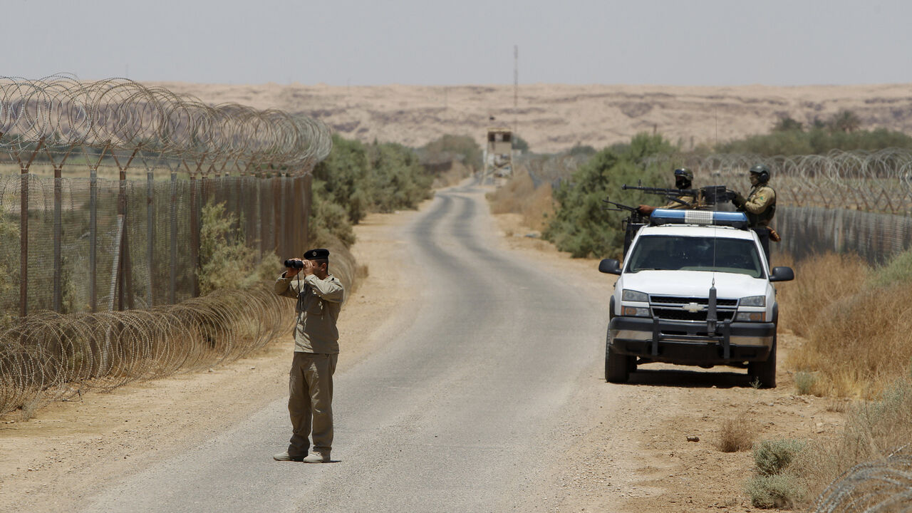 An Iraqi soldier looks through a pair of binoculars near the Iraqi-Syrian borders at the Abu Kamal-qaim border crossing, the main border post between Iraq and Syria An Iraqi soldier looks through a pair of binoculars near the Iraqi-Syrian borders at the Abu Kamal-qaim border crossing, the main border post between Iraq and Syria, July 20, 2012. REUTERS/Saad Shalash (IRAQ - Tags: CIVIL UNREST MILITARY) - GM1E87K1QAO01