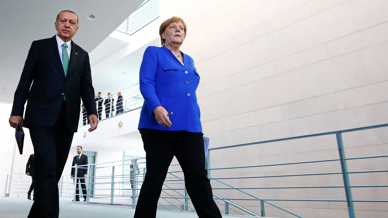 German Chancellor Angela Merkel and Turkish President Tayyip Erdogan leave after a news conference at the chancellery in Berlin, Germany, September 28, 2018. REUTERS/Fabrizio Bensch - RC1176EAE300