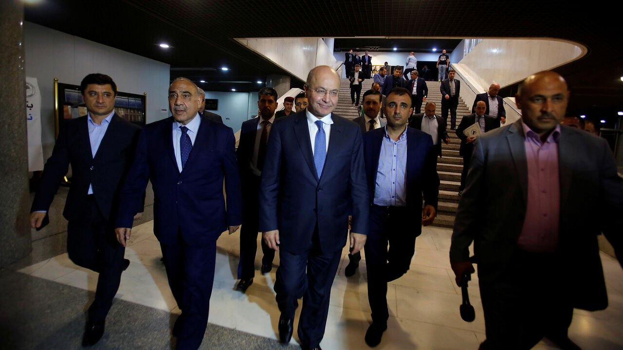 IRAQ-POLITICS/ Barham Salih, Iraq's newly elected president, walks with Iraq's new Prime Minister Adel Abdul Mahdi at the parliament headquarters, in Baghdad, Iraq October 2, 2018. REUTERS/Khalid al Mousily - RC1CC4B29CE0