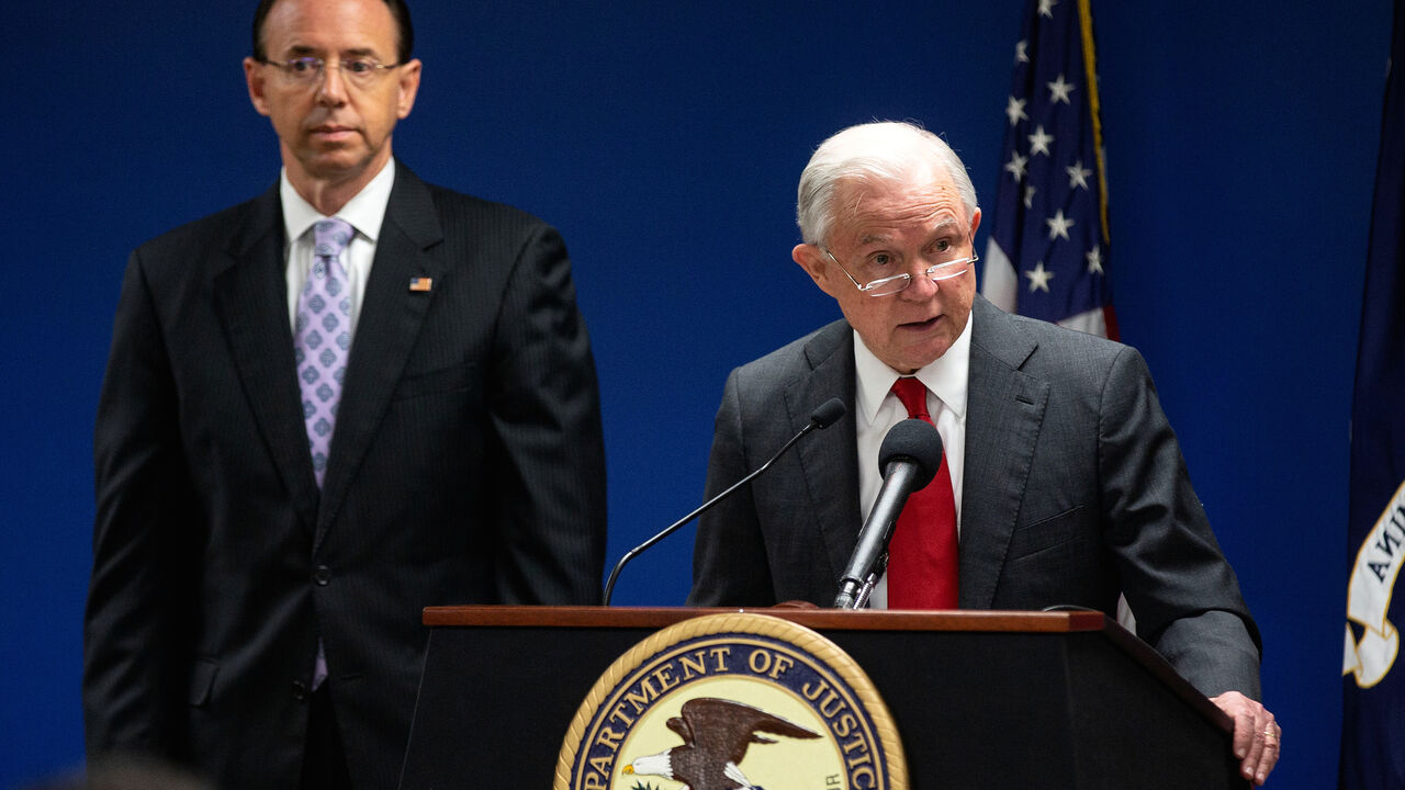 USA-JUSTICE/SESSIONS U.S. Attorney General Jeff Sessions speaks alongside Deputy Attorney General Rod Rosenstein during a news conference to announce efforts to reduce transnational crime, at the U.S. District Attorney's office, in Washington, U.S., October 15, 2018. REUTERS/Al Drago - RC17479B8800