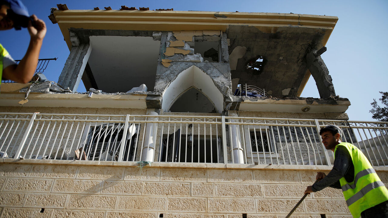 Municipality employees work next to a house that the Israeli military said was hit by a rocket fired from the Gaza Strip, in Beersheba, southern Israel October 17, 2018. REUTERS/Amir Cohen TPX IMAGES OF THE DAY - RC1F454D7B10