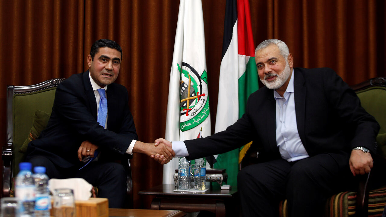 ISRAEL-PALESTINIANS/GAZA Hamas Chief Ismail Haniyeh shakes hands with Egyptian senior security official Ayman Badie during their meeting in Gaza City October 18, 2018. REUTERS/Mohammed Salem - RC1129B69360